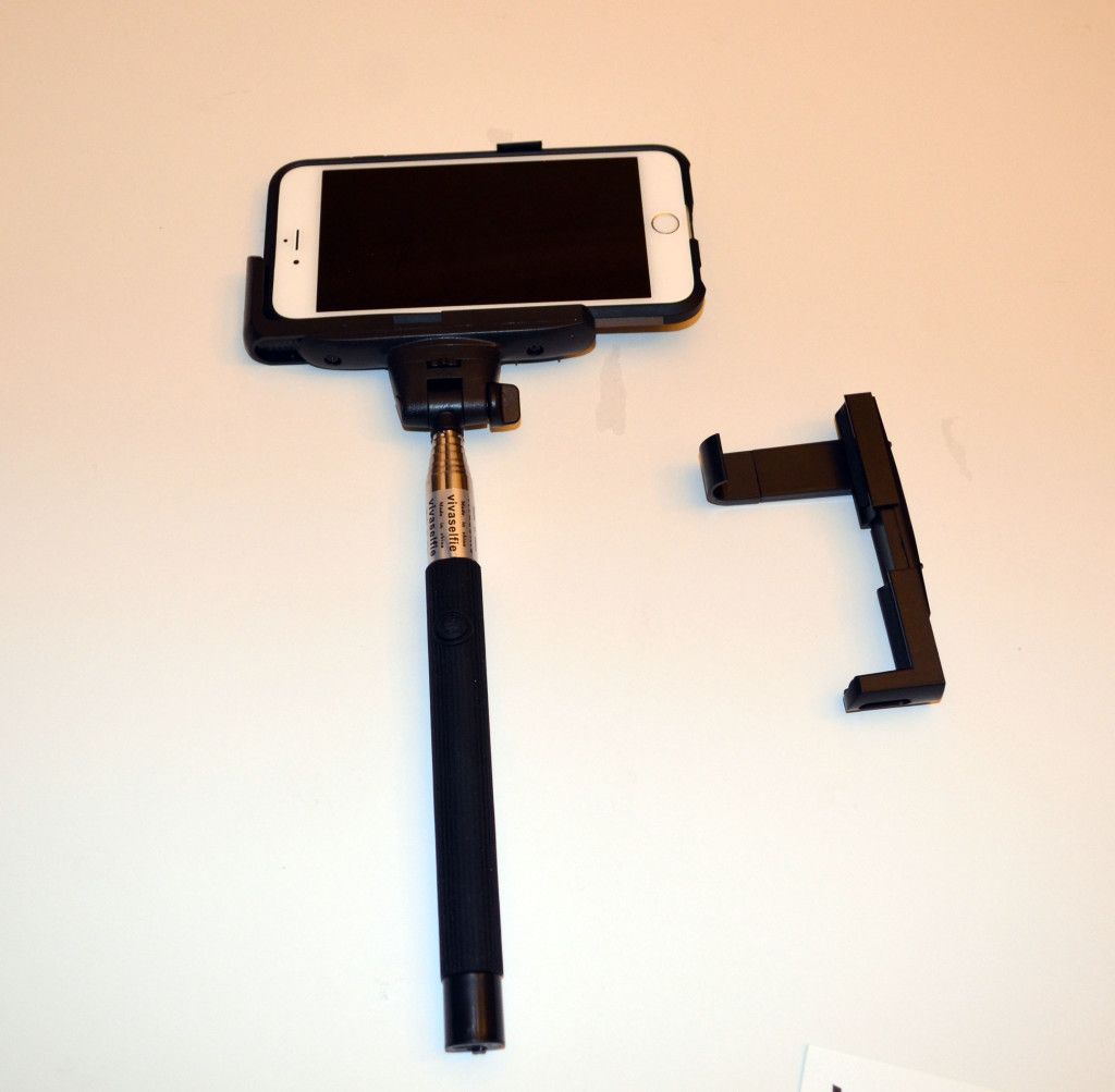 Using one of the included clamps to secure my cased iPhone 6 Plus.