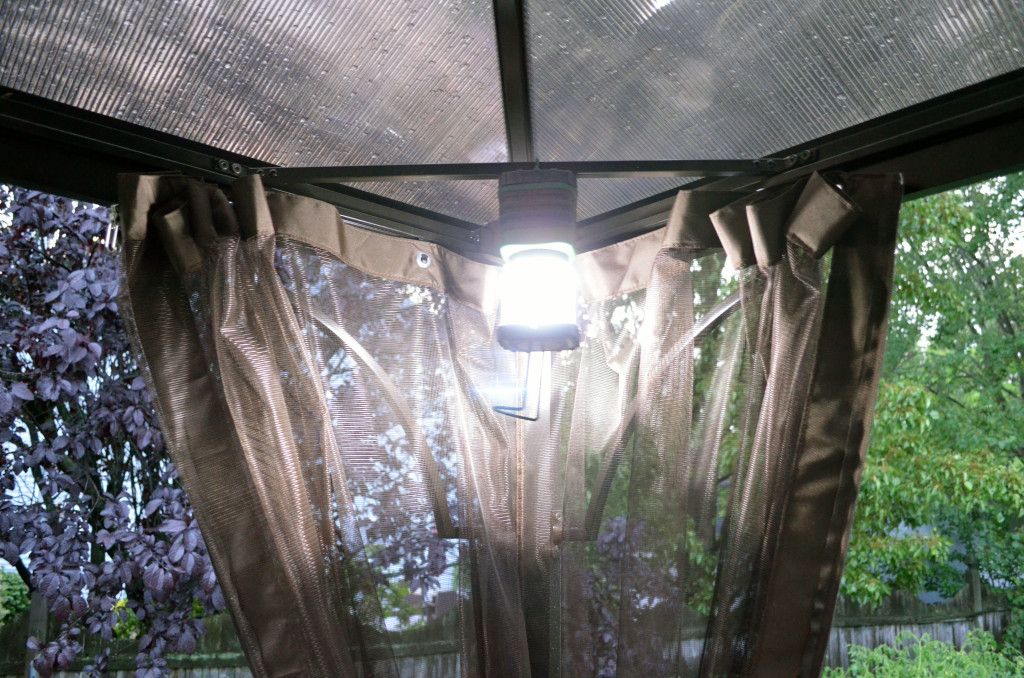 Hanging the lantern in the corner of my gazebo.