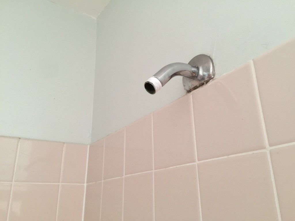 Remove the old shower head and then wrap the plumber's tape around the pipe thread.