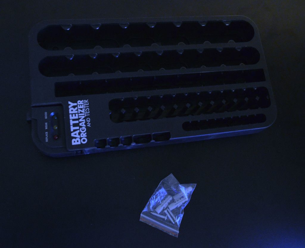 Inside the box is the battery holder with removable tester, as well as wall mounting hardware.