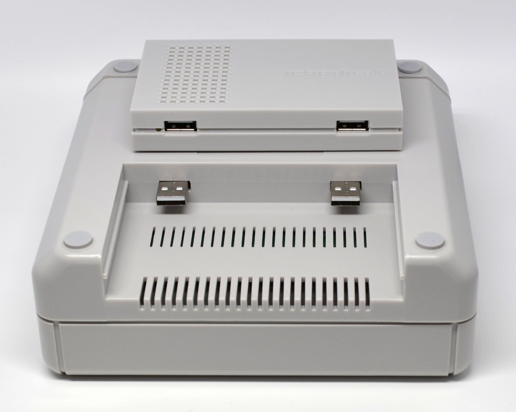 The main part of the console sitting on top of the bottom of the cartridge unit.