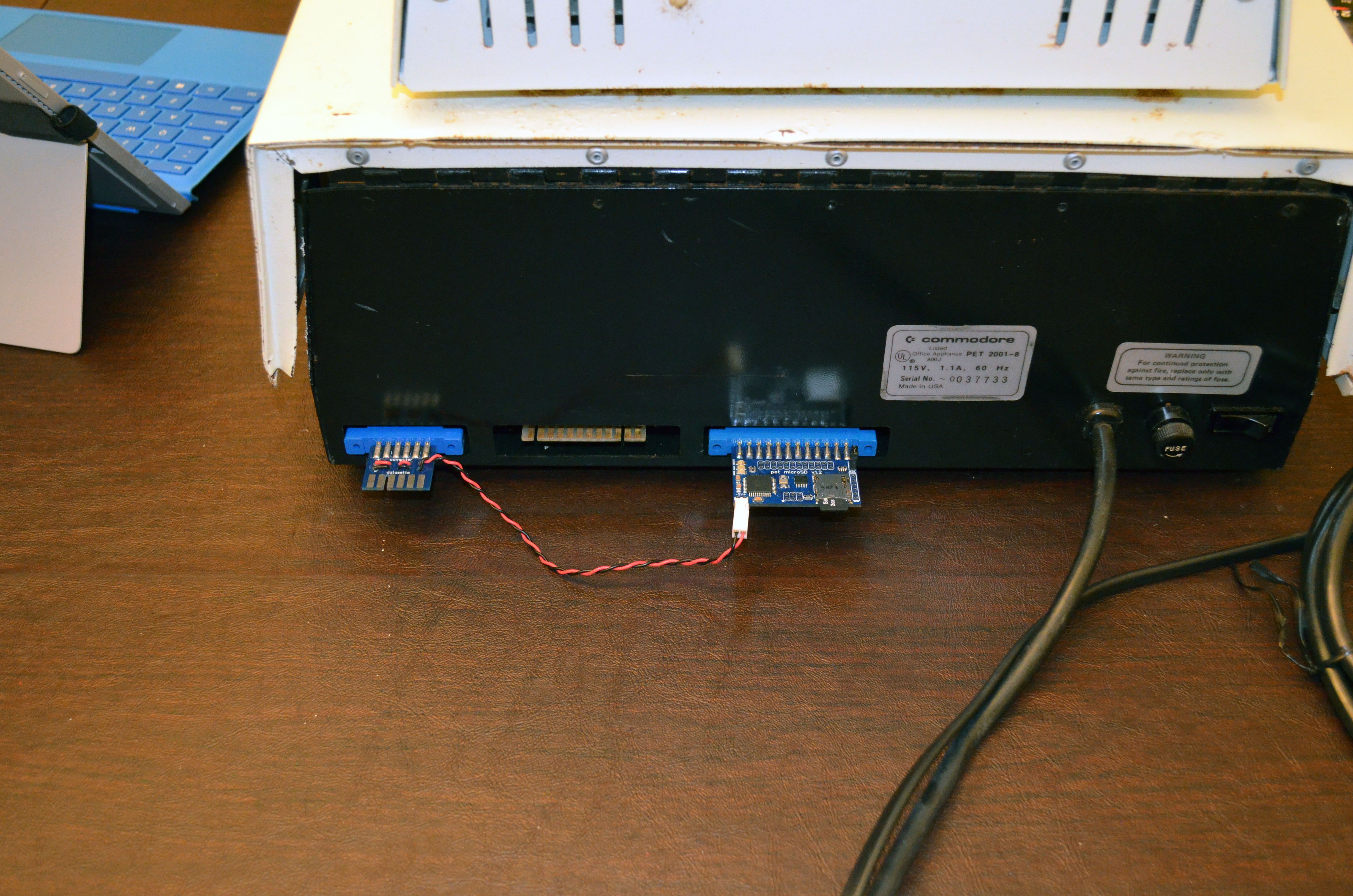 It's in. Distressingly, the motherboard moved quite a bit up and down as I was inserting the PET microSD into the IEEE-488 port (far right; Power is supplied from the datasette drive connector on the far left).