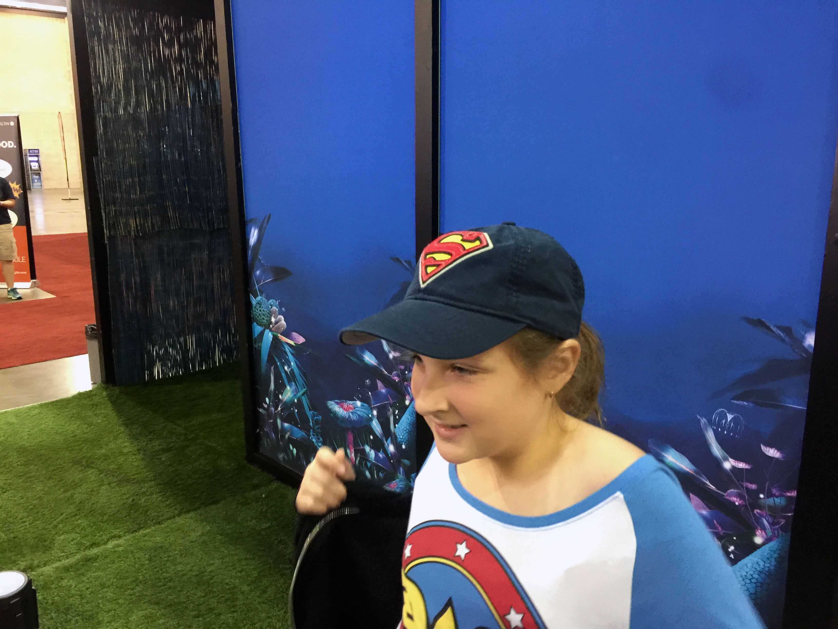 Olivia getting a morph done at the Avatar Cirque du Soleil booth.