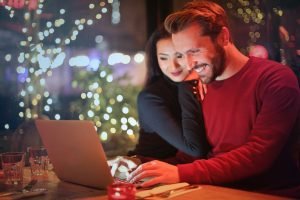 Woman and man looking at laptop screen and smiling