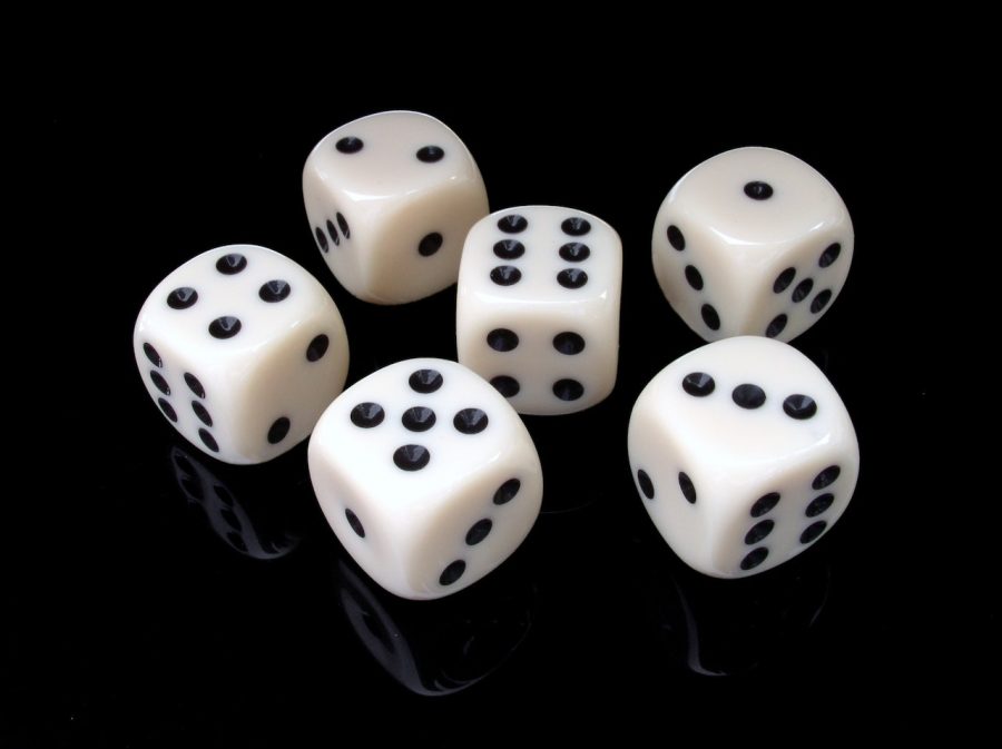 Six six-sided dice on a black background