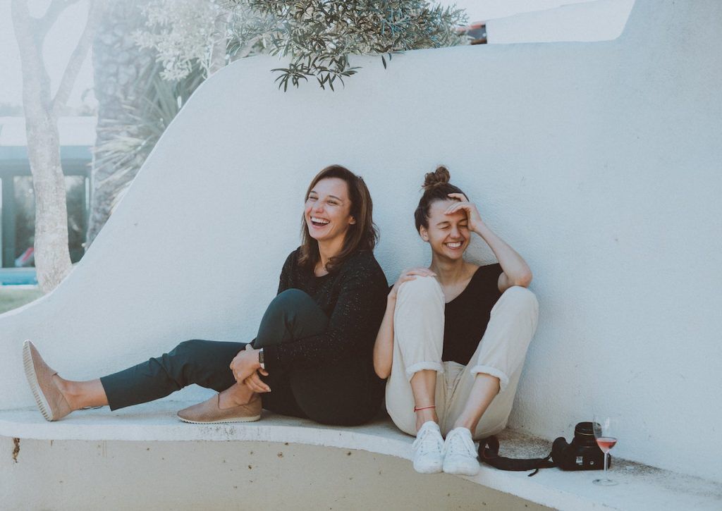 Two women sitting outside together enjoying a nice day