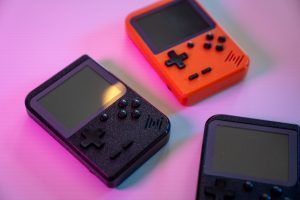 Generic handheld game systems on a pink background