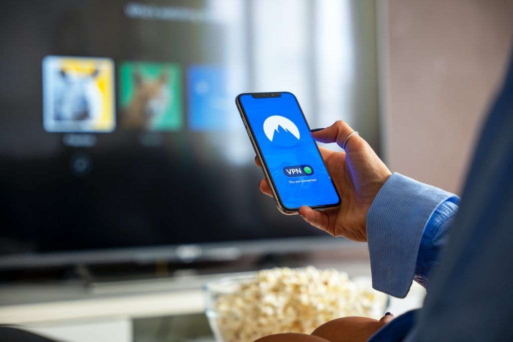 Hand using a VPN on a smartphone screen
