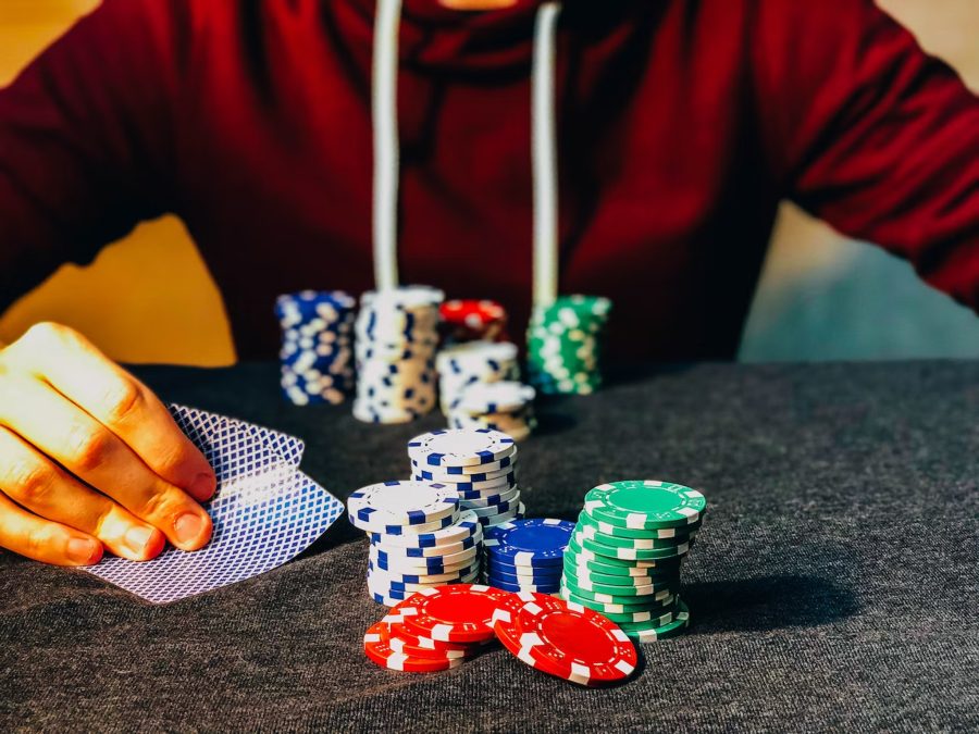 Man hiding playing cards and poker chips
