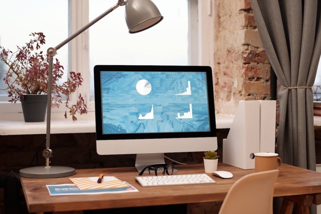 Charts on a computer screen on a desk.