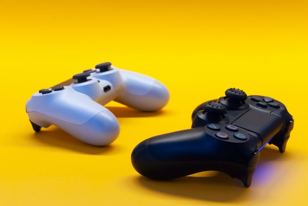 Two PlayStation controllers facing each other