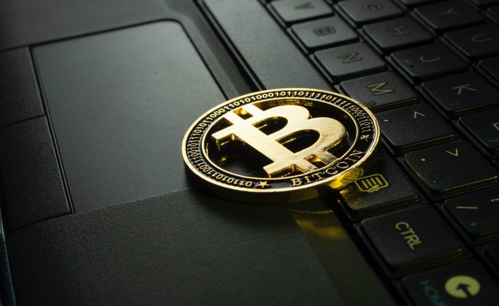 Physical cryptocurrency on a zoomed in laptop keyboard