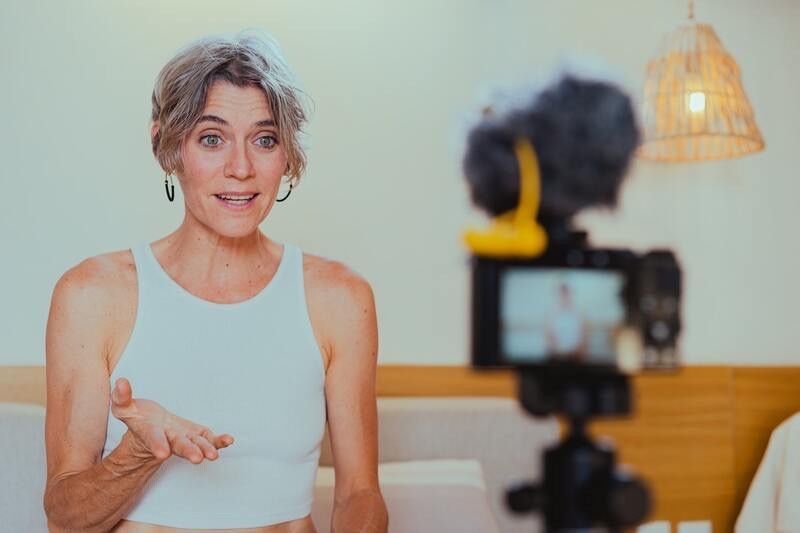 Woman live streaming in front of a camera