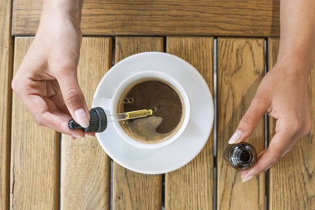 Placing CBD oil in a warm beverage