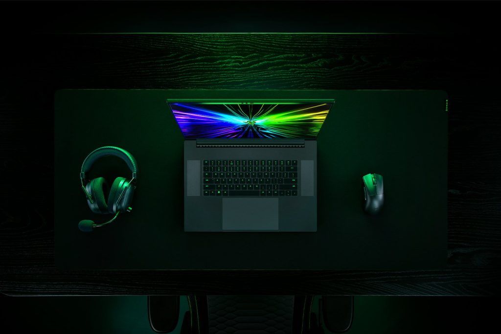 Razer Blade 18 with wireless headphones and a mouse