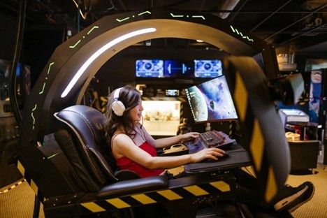 woman playing a game on a specialized PC rig