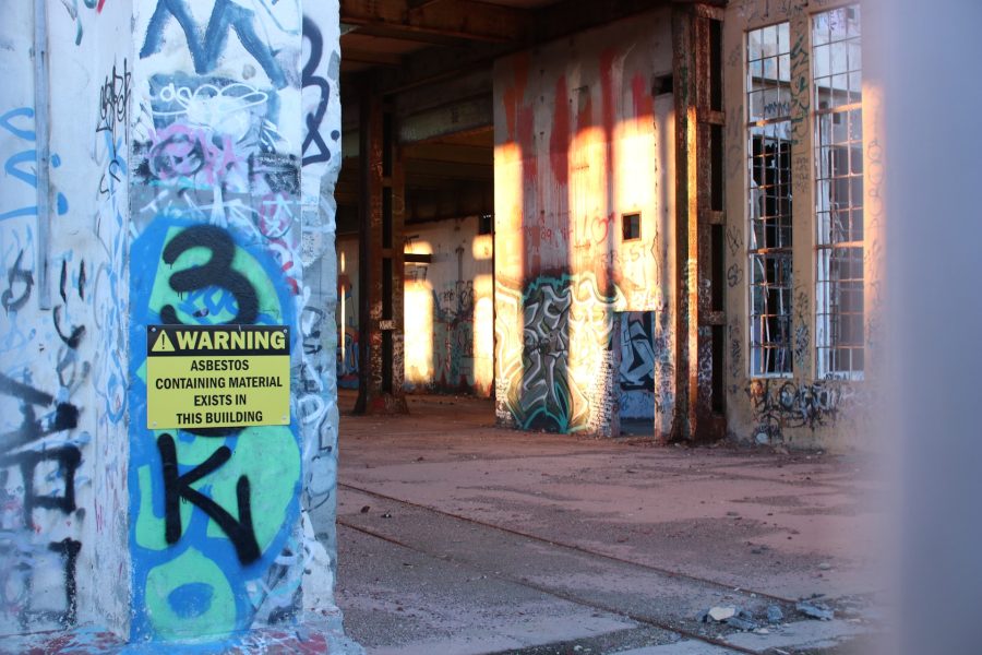 abandoned building with asbestos warning sign