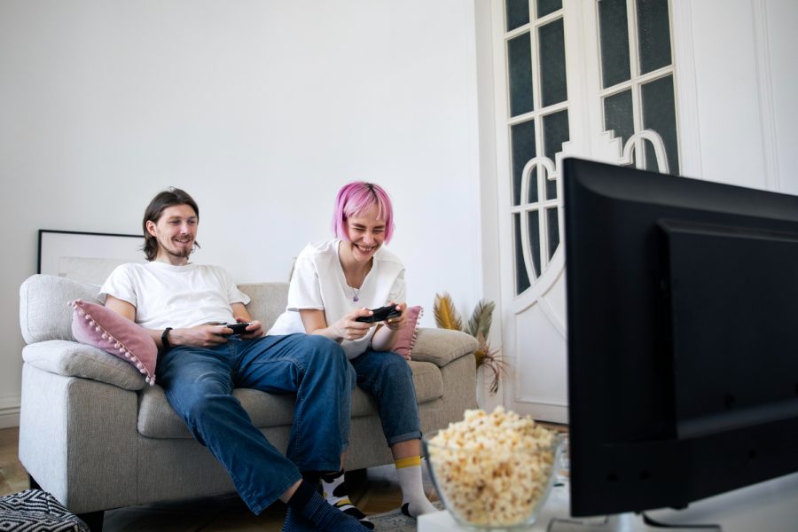 Cute couple playing videogames at home