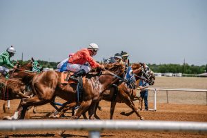 jockeys racing horses