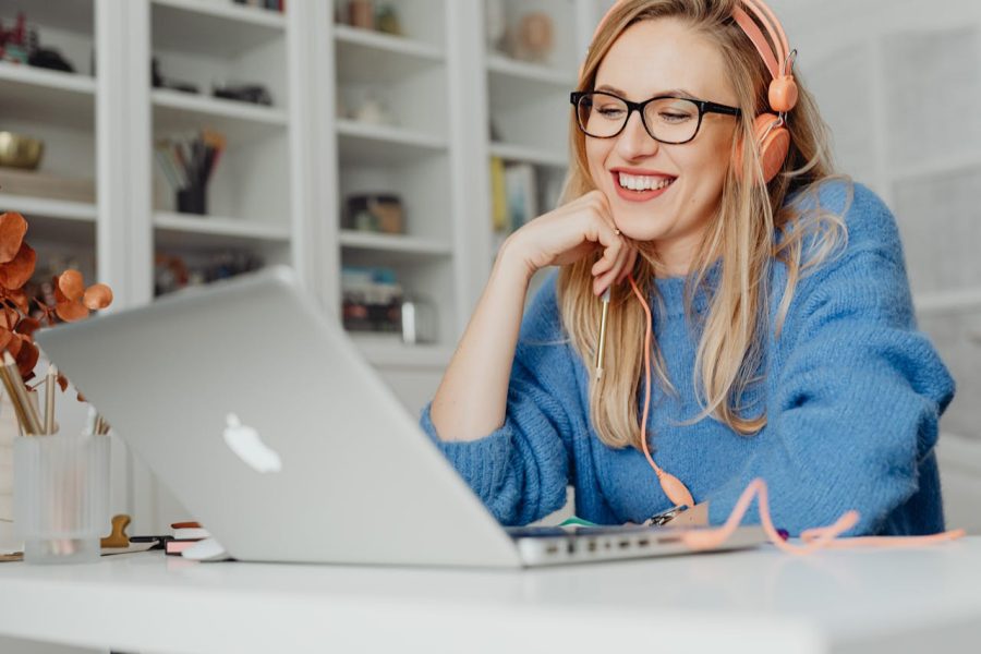 A Woman wearing Eyeglasses Looking the Laptop