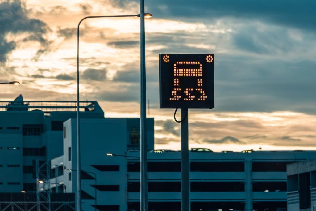 Urban parking sign with cloudy sky backdrop