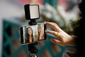 Woman Using Smartphone for Recording