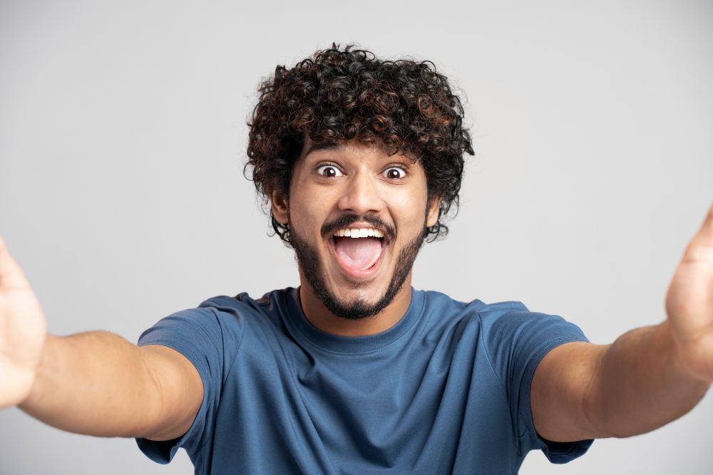 Man wearing t-shirt expressing joy