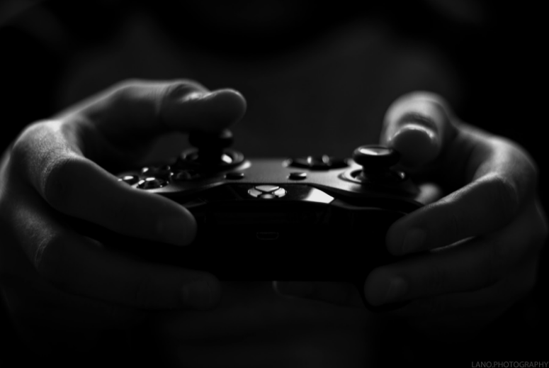 Close-up of hands on Xbox controller