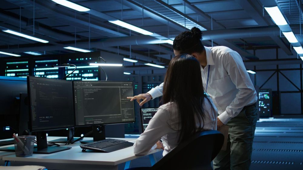 Computer scientists in data center managing and maintaining databases