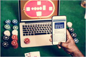 Hand holding card playing online gambling