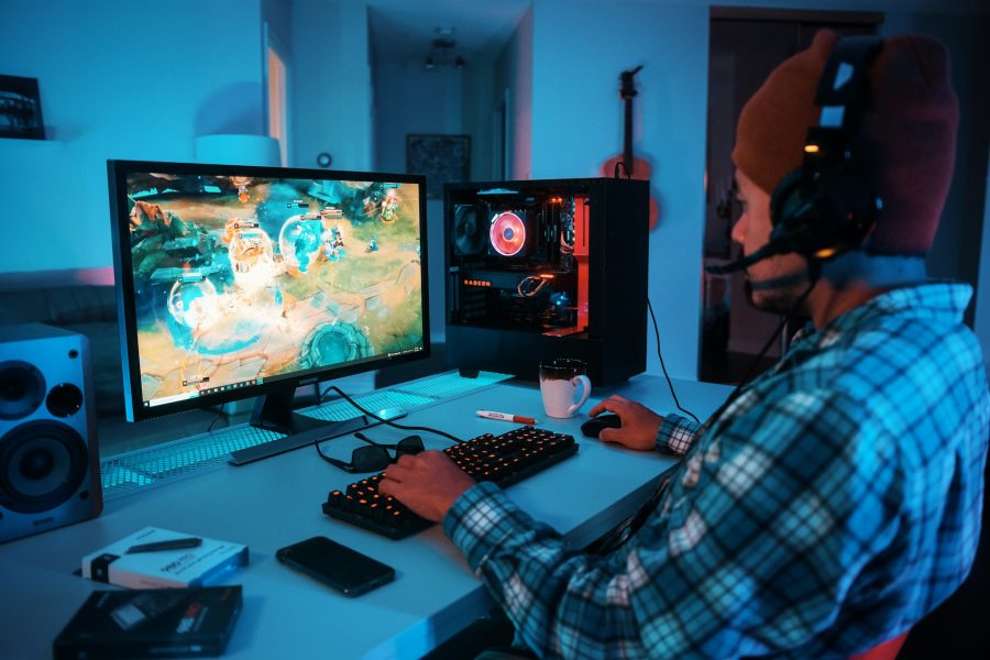 a person wearing headphones and using a computer to play