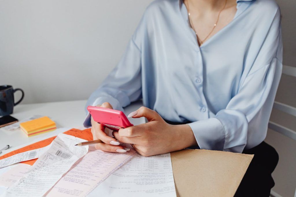 Woman Holding a Pink calculator