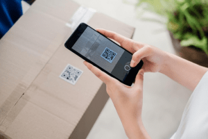 woman scanning a QR code on a package with her smartphone