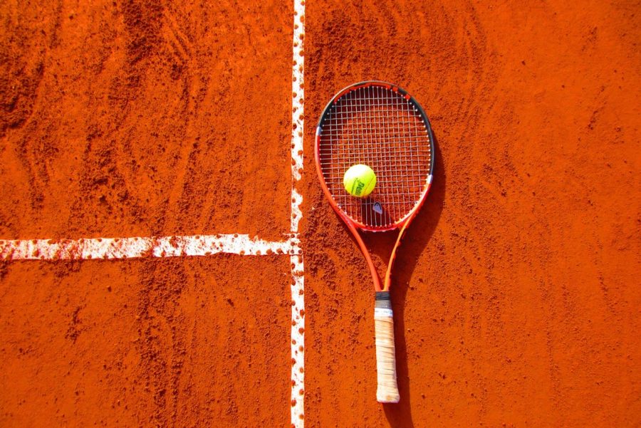 Tennis Ball on Tennis Racket on Clay Court