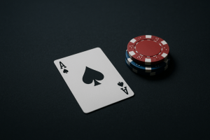ace of spades and poker chips on black background