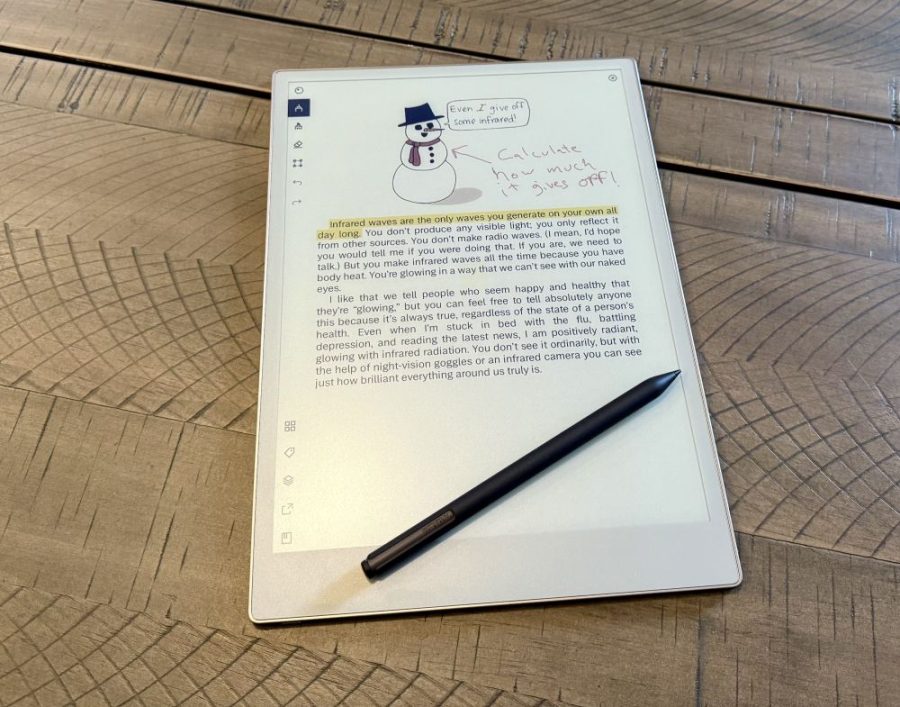 Remarkable Paper Pro with pen showing a color PDF with writing on it.