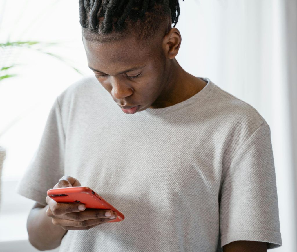 man looking down at smartphone