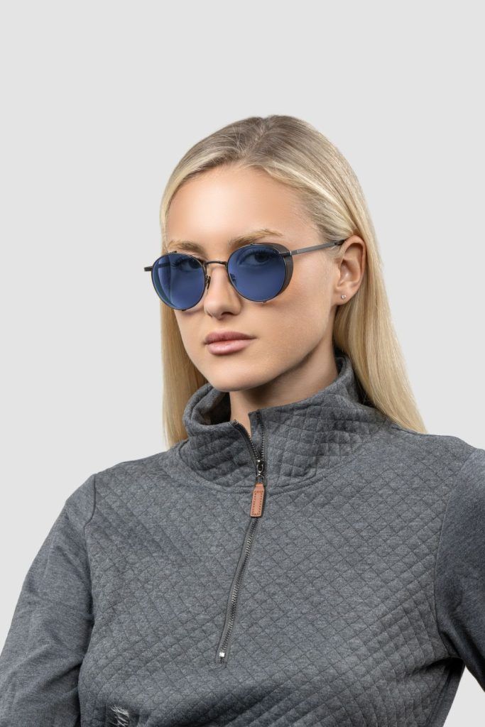 Blonde model wearing GUNNAR x Amazon Studios Fallout: New Vegas Glasses.