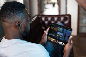 man watching movie on tablet