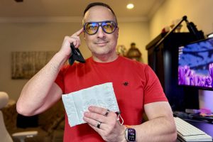 Man in red shirt wearing GUNNAR x Alienware ROSWELL Conspiracy Blue Glasses.