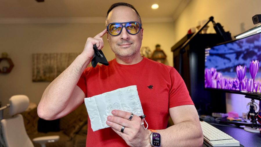 Man in red shirt wearing GUNNAR x Alienware ROSWELL Conspiracy Blue Glasses.