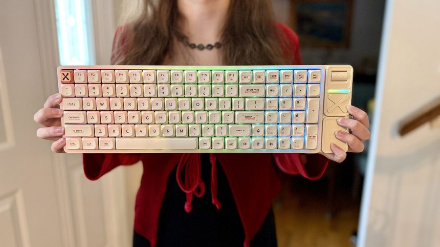 Woman holding an IQUNIX Magi96 Pro keyboard.