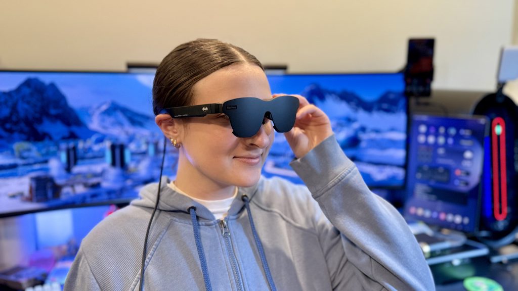 RayNeo Air 4 Pro AR glasses being worn by a young woman.